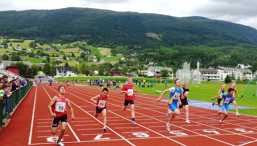 Personar som spring på løpebane. Foto.